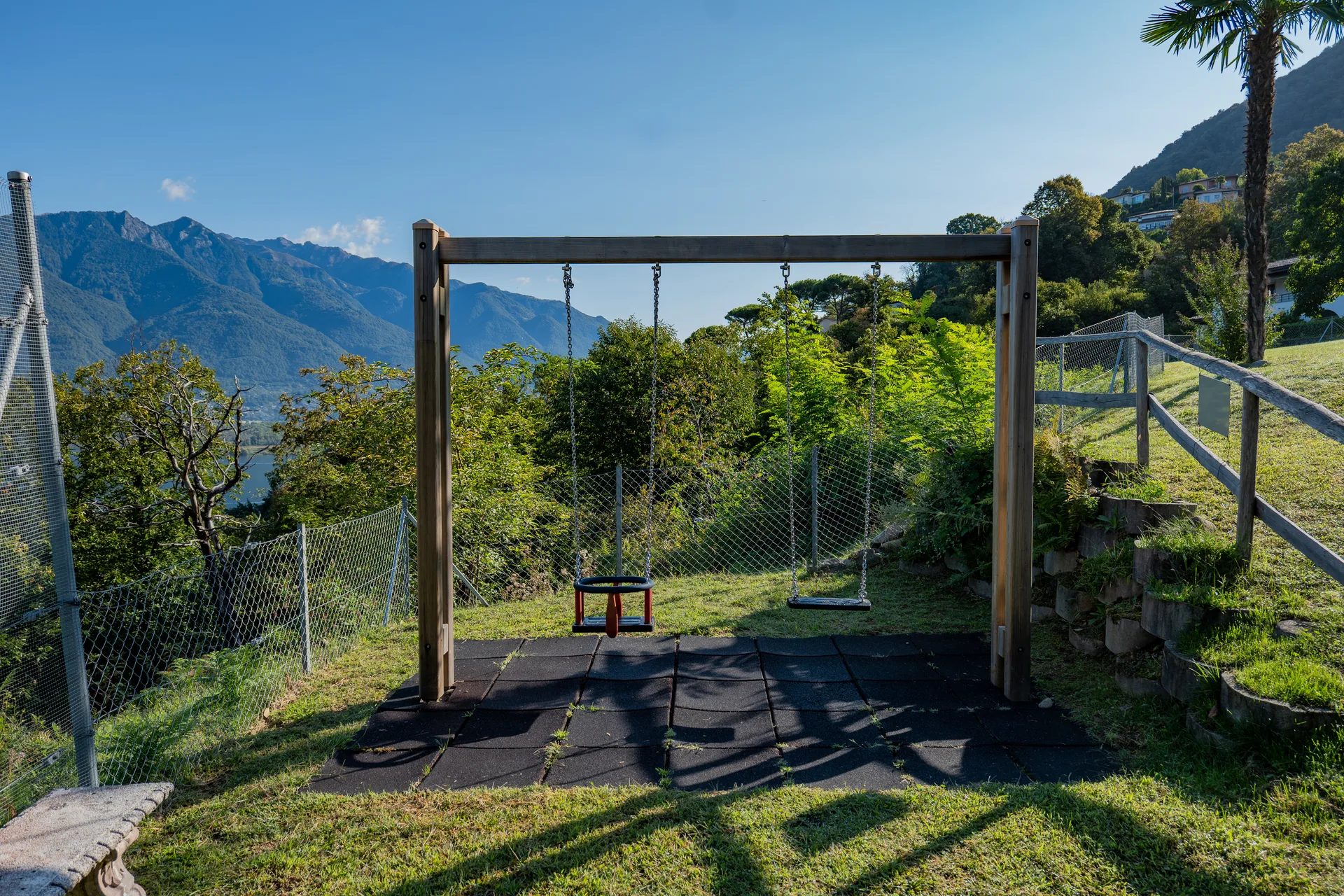 Schaukeln auf dem Spielplatz der Residenza Viramonte mit Blick auf Berge und Lago Maggiore